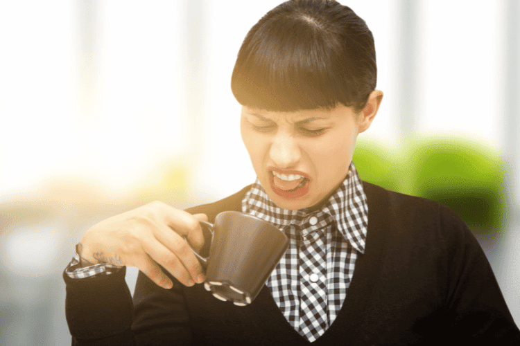 A woman drinking bad coffee